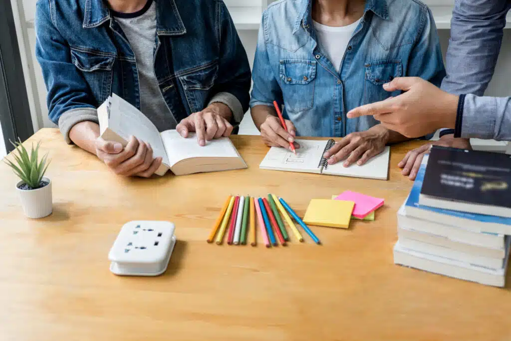 Students working together at a desk in an English for Academic Purposes classroom
