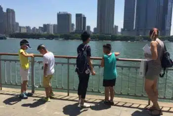 TEFL teacher engaging with teen students on excursion