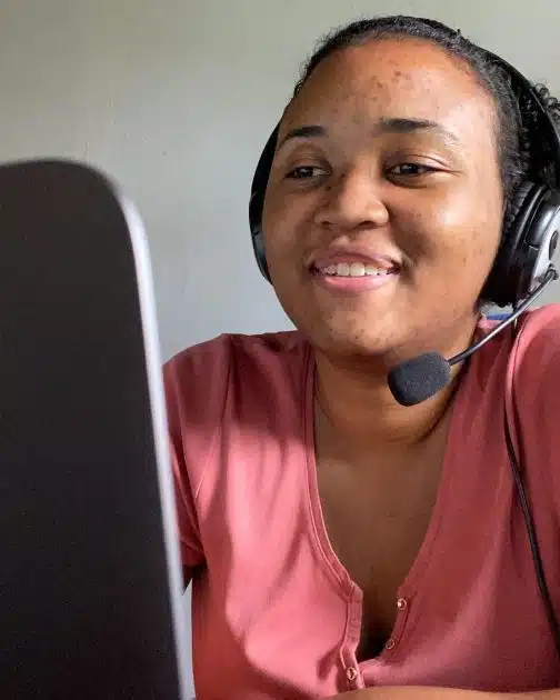 TTA alumni Maryse at her laptop teaching an online lesson