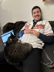 Matt trying to teach online while a cat sits on his lap