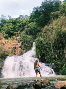Teacher Taylor looking at a waterfall