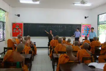 TEFL teacher writing English vocabulary on a chalkboard in a monastery